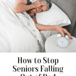 A senior lying in bed next to an alarm clock, highlighting the question of how to stop seniors from falling out of bed