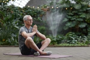 An older man meditating, highlighting ways to stay active