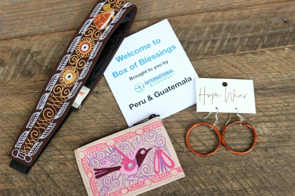 A wooden table with three different Box of Blessings products