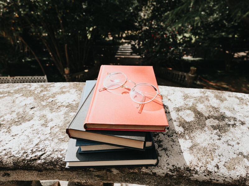 A small pile of books outside, highlighting the best books for dementia caregivers