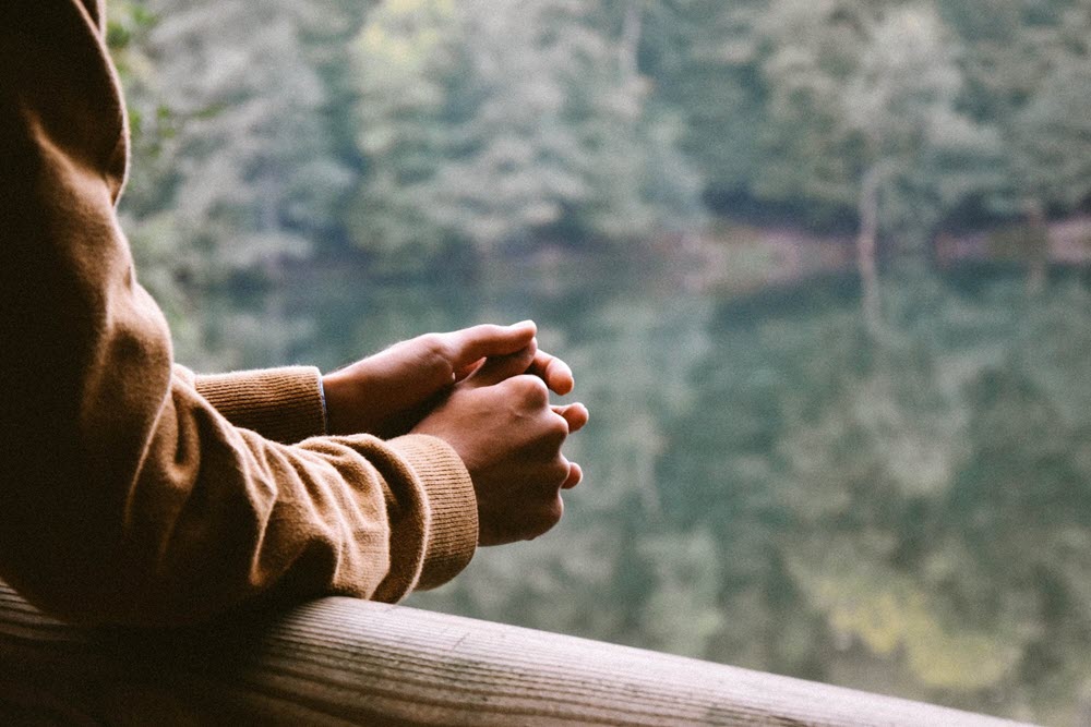 Someone looking out over a river, highlighting the idea of multicultural caregiving and mental health