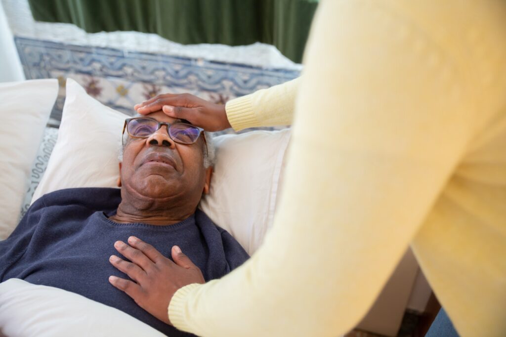 A senior lying in bed in an assisted living facility