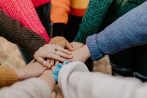 Women with their hands in a circle