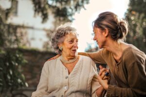 An older woman talking to her daughter or granddaughter