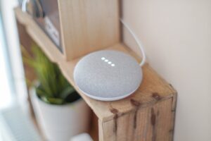 A smart home speaker on a bookcase