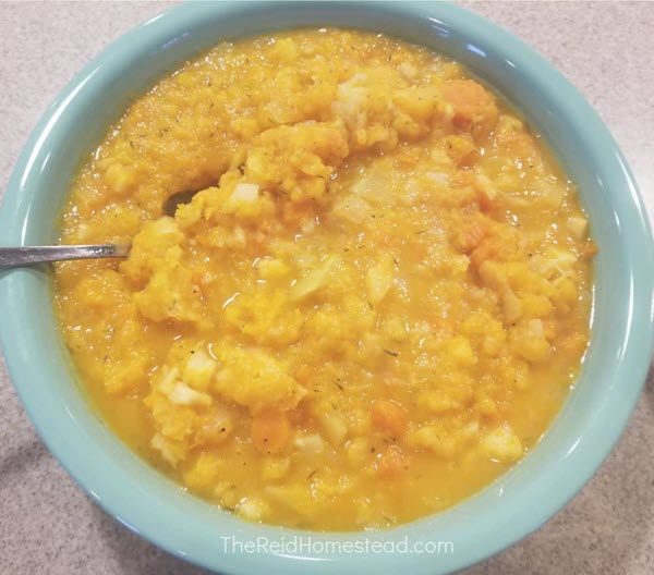 A small dish of root veggie mash with a spoon