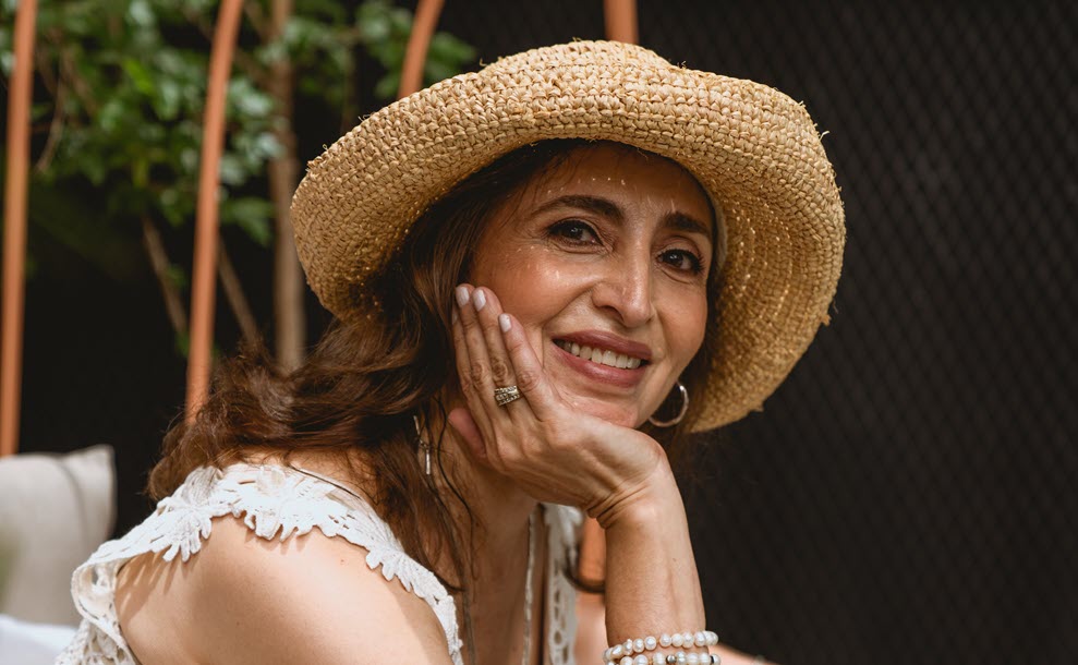 A beautiful older woman resting her chin on her hand