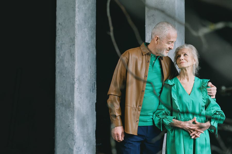 An older couple standing outside