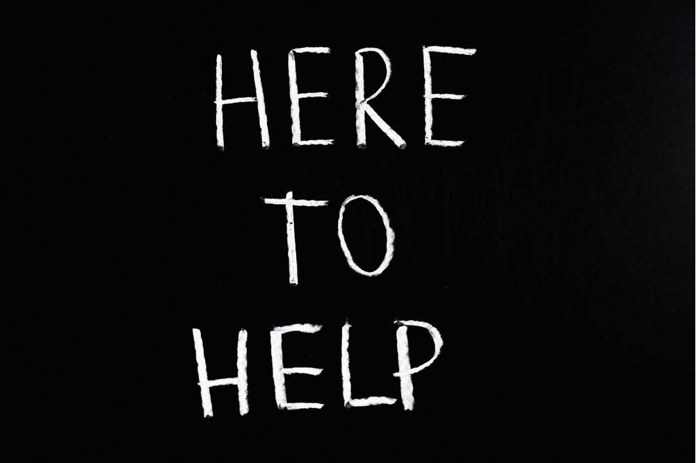 White text that says 'here to help' against a black background