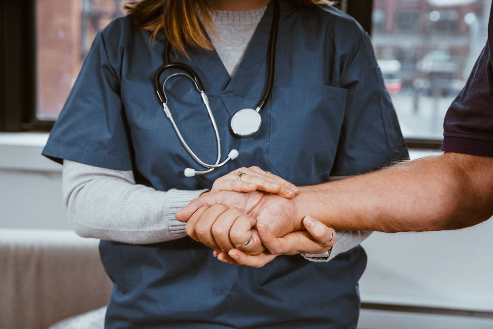 A nurse talking to a patient about Power of Attorney paperwork