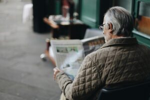 An older man reading a paper, highlighting the idea of advance care planning for dementia