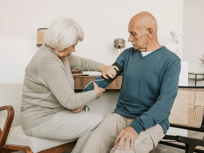 An older woman acting as a caregiver for her spouse