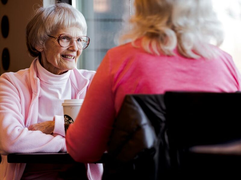 Talking about advance planning in a cafe, highlighting the idea of talking to aging parents about end-of-life planning